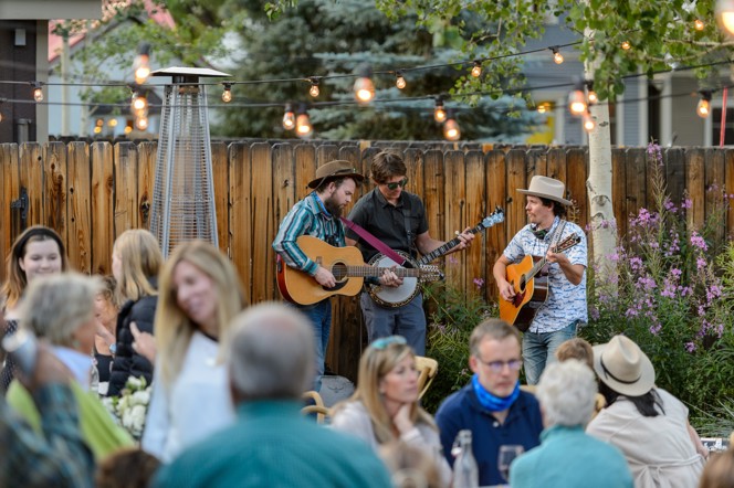 A bluegrass band performing in an outdoor space.